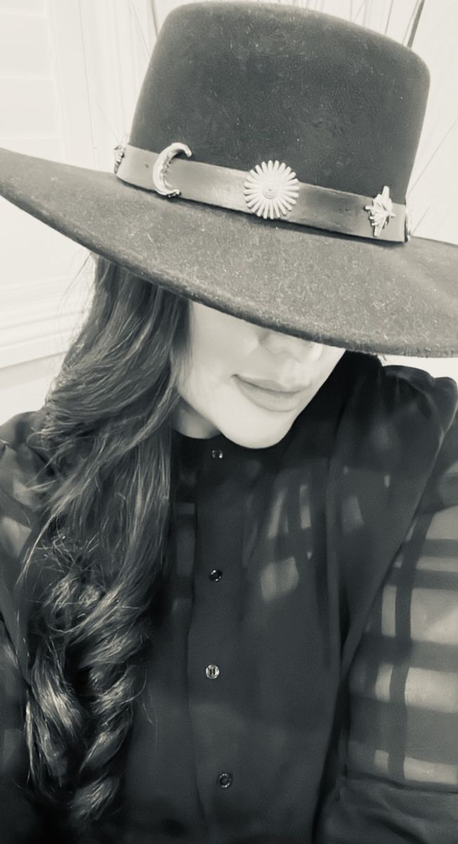 Black and white photo of Cherie Kaina in a black hat