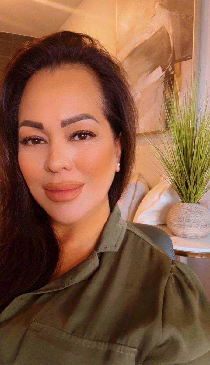 Cherie Kaina smiling in an olive green shirt
